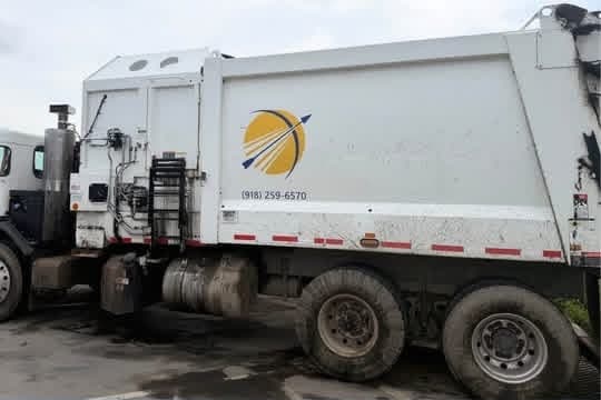 Heavy truck wheels and tires before cleaning, coated in grey road grime and brake dust