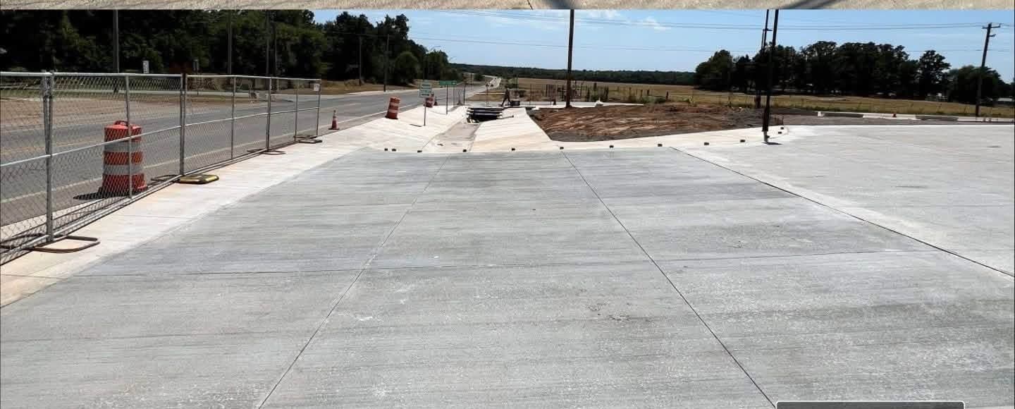 The same concrete apron after rust treatment, with uniform grey concrete and no orange banding