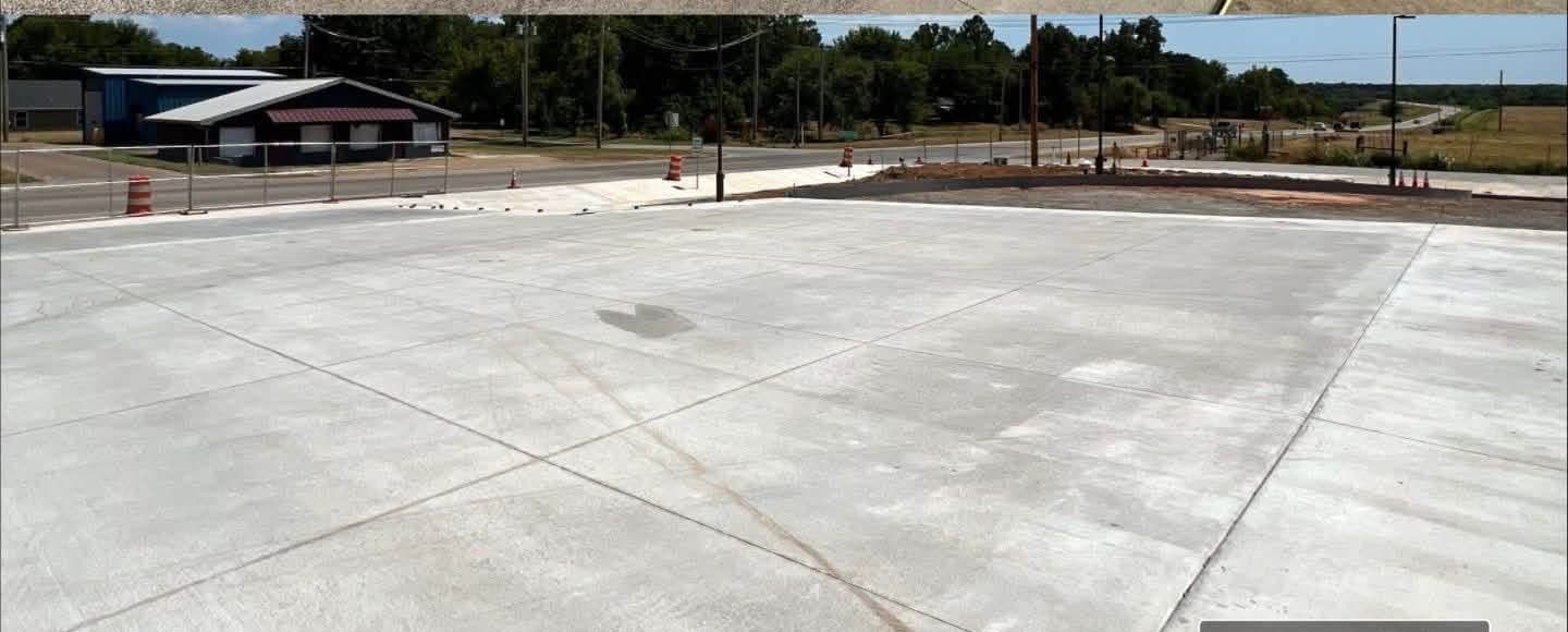 The same parking slab after treatment, with the orange cast removed and consistent grey concrete