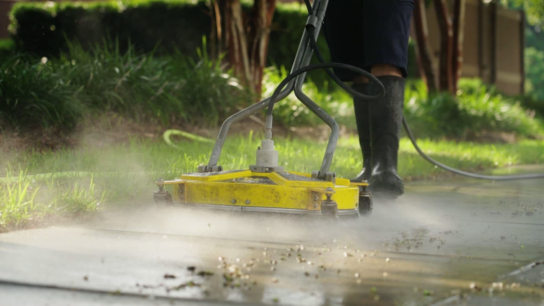A surface cleaner running across a residential concrete walkway in Charleston, SC