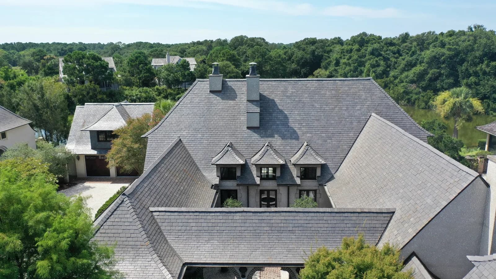 Aerial view of a cleaned slate roof on a Kiawah Island, SC home, even grey slate with no algae staining